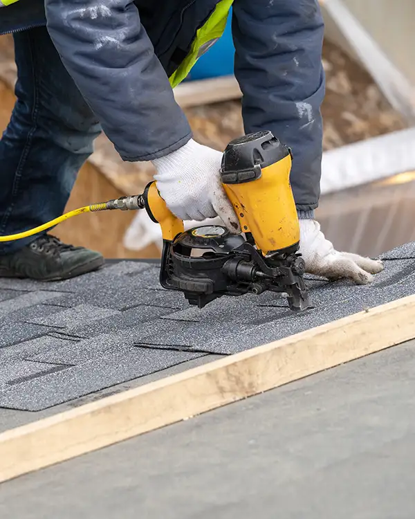 Roofer installing new shingles